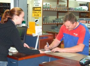 A customer signing for products from his supplier.