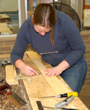 A woman working with hand tools.